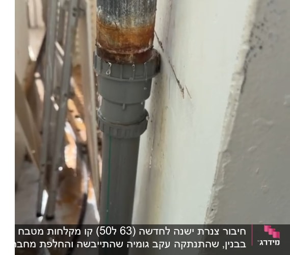 צינור חלוד עם נזילה על קיר חיצוני